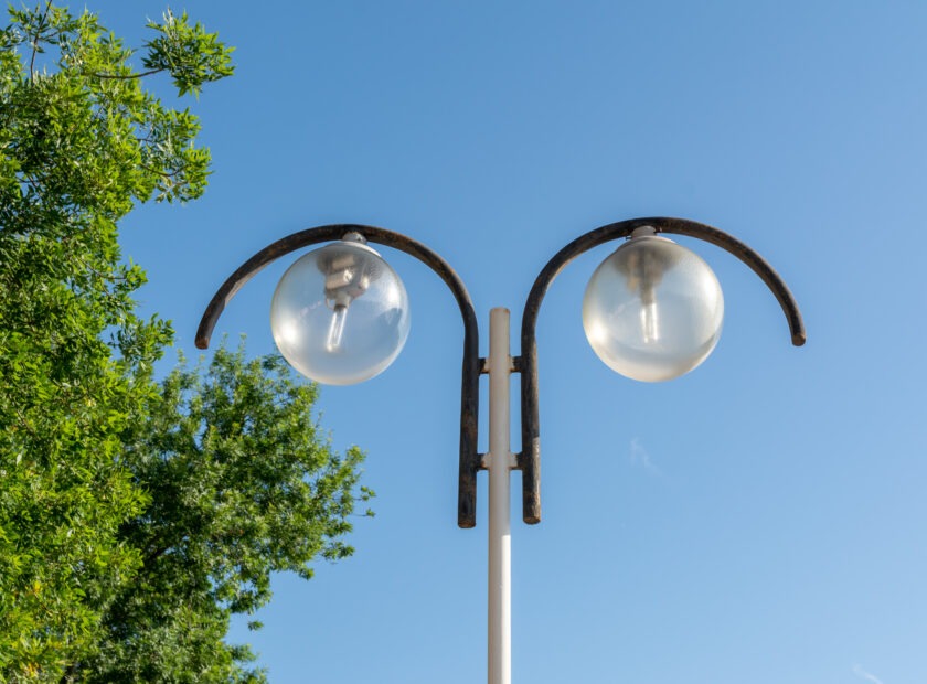 Street lamp with circular shades on the background of blue sky